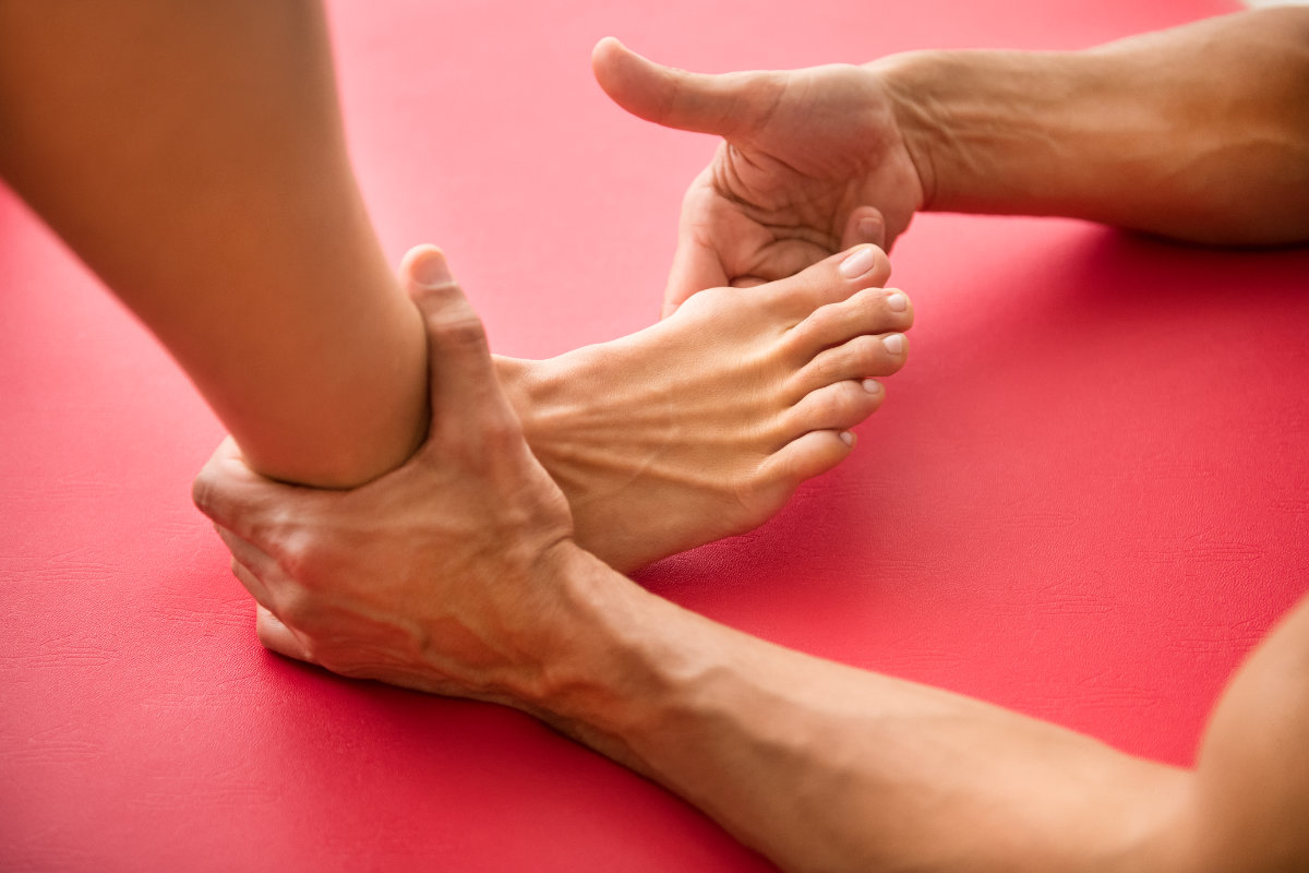 Osteopath assessing a foot injury